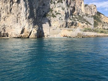 Scenic view of sea against rock formation