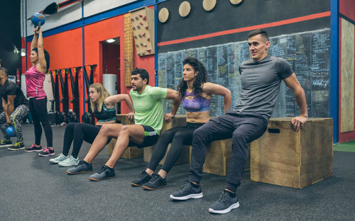 Group of people sitting on the wall