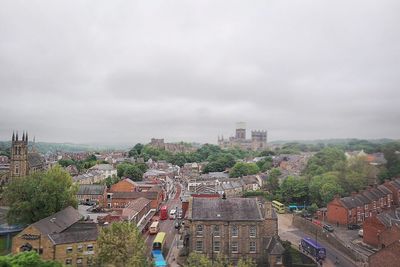 Cityscape against cloudy sky