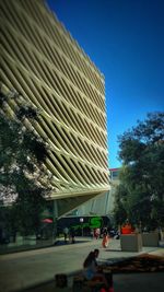 Low angle view of modern building against blue sky