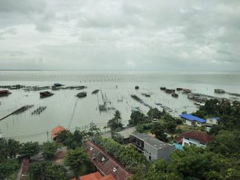 High angle view of buildings by sea against sky