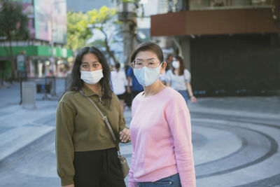 Portrait of female friends standing outdoors