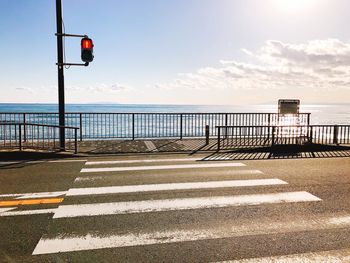 Road by sea against sky