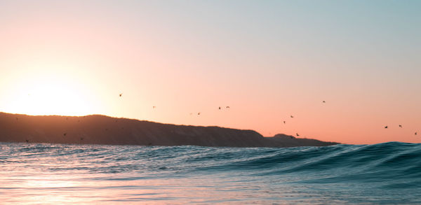 Scenic view of sea against sky during sunset