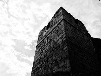 Low angle view of building against cloudy sky