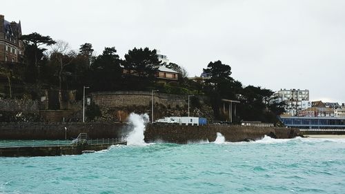 Water fountain in swimming pool against sky