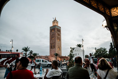 People on street with buildings in background