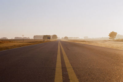Surface level of road against clear sky