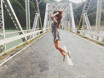 Full length of woman standing by railing