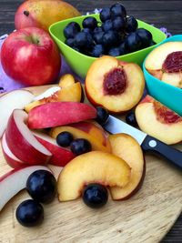 High angle view of fruits in bowls and cutting board