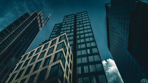 Low angle view of skyscrapers against sky at night