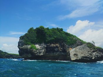 Scenic view of sea and rock formation against sky
