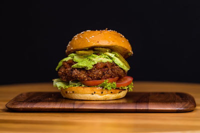 Close-up of burger against black background