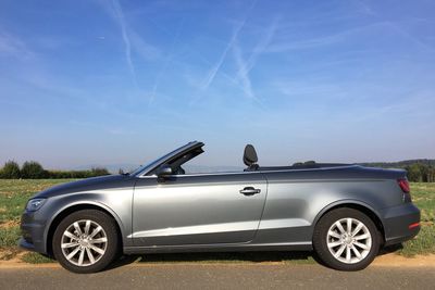 Convertible car on road against sky