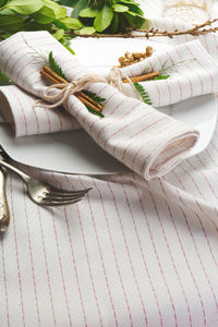 Napkins with cinnamons in plate on tablecloth