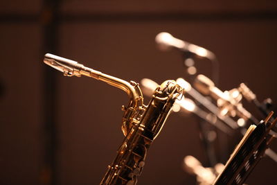 Close-up of saxophone and microphones at stage theater