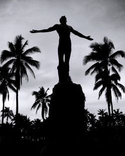Low angle view of statue of palm tree against sky