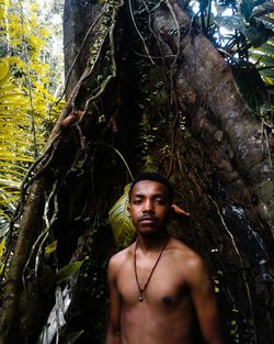 Portrait of young man in forest