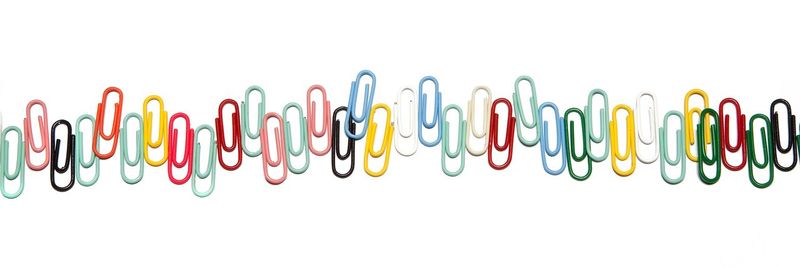 Close-up of colored pencils over white background