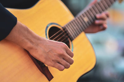 Man playing guitar on the street. retro style.