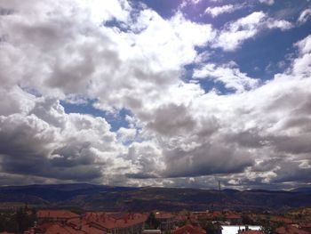 Houses against cloudy sky