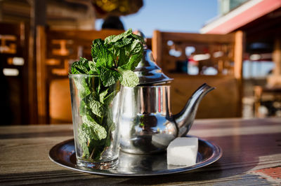 Traditional moroccan tea pot with a cup outside ready to drink