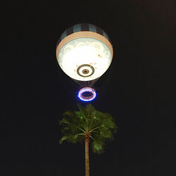 Close-up of illuminated lighting equipment against black background