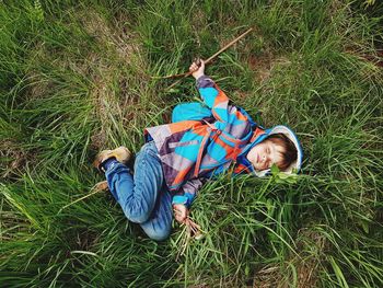 High angle view of child lying on grass