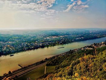 High angle view of sea by city against sky