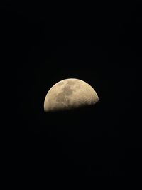 Low angle view of half moon against sky at night