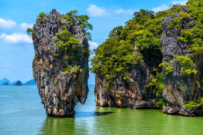 Panoramic view of rock formation in sea against sky