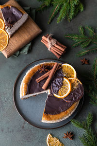 Cheesecake with chocolate decorated slices of dried oranges. festive christmas decoration.