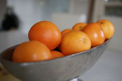Close-up of orange fruits in weight scale