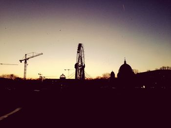 Low angle view of silhouette built structures against sky