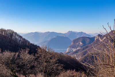 Scenic view of mountains against clear blue sky