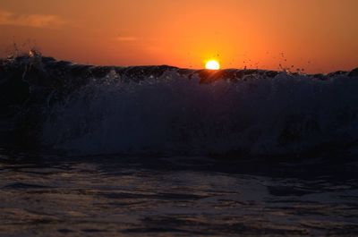 Scenic view of sea against romantic sky at sunset