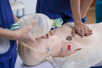 Cropped image of person learning cpr in hospital