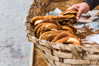 Close-up of hand holding wicker basket