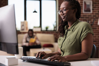 Young woman using laptop on table