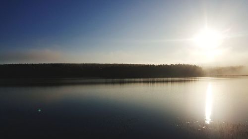 Scenic view of lake against sky at sunset