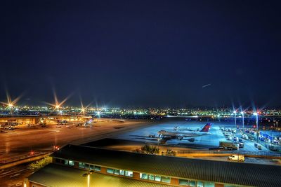 Illuminated commercial dock against sky at night