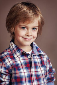 Portrait of cute boy against wall