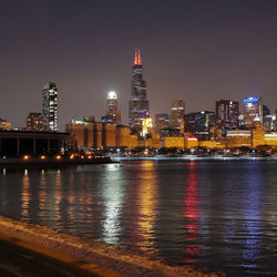 Illuminated buildings in city at night