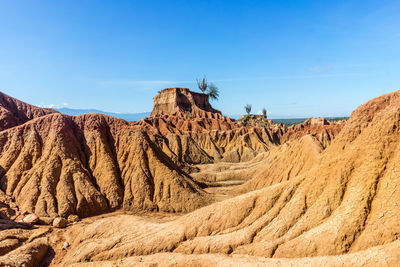 Scenic view of rocky mountain against blue sky