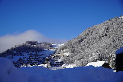 Scenic view of snowcapped mountains against clear blue sky