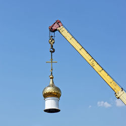 Low angle view of crane against clear sky