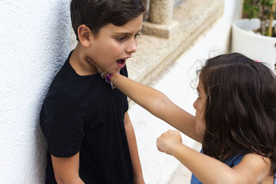 Girl fighting with boy outdoors