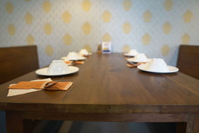 Close-up of empty tables and chairs in restaurant