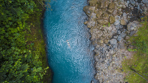 High angle view of water flowing through rocks