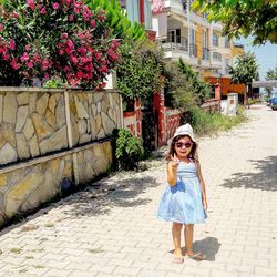 Full length portrait of smiling woman walking outdoors